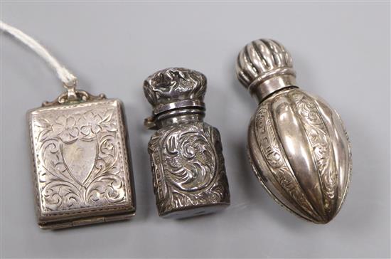 A late Victorian miniature scent flask, one other silver scent flask and a George V silver stamp case.